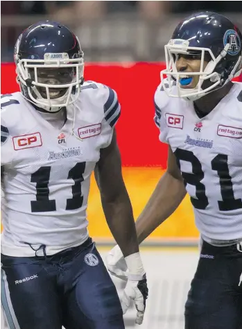  ?? DARRYL DYCK/THE CANADIAN PRESS ?? Argonauts’ Natey Adjei, left, celebrates his touchdown against the B.C. Lions with Tori Gurley during Toronto’s comeback victory in Vancouver in Week 5 of the CFL season.