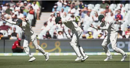  ?? — AP ?? Joyous moment: (From left) Australia’s Steve Smith, Tim Paine and Peter Handscomb celebratin­g the fall of England’s last wicket during their second Test match at the Adelaide Oval yesterday.