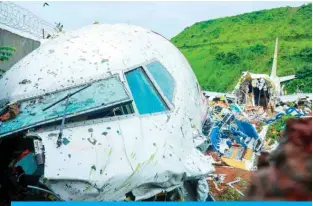  ?? — AFP ?? KARIPUR, India: Officials inspect the wreckage of an Air India Express jet at Calicut Internatio­nal Airport yesterday.