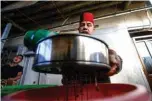  ??  ?? Ishaaq Kremed pours water over tamarind to soak them at his home.