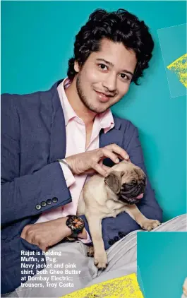  ??  ?? Rajat is holding Muffin, a Pug. Navy jacket and pink shirt, both Ghee Butter at Bombay Electric; trousers, Troy Costa