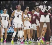  ?? Associated Press ?? The South Carolina bench reacts after the defeating Lousiville 72-59 in the Women’s Final Four NCAA Tournament on Friday in Minneapoli­s. South Carolina advances to the finals.