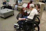  ?? JOHN BAZEMORE — THE ASSOCIATED PRESS ?? Naomi Adams checks on residents after they received the Pfizer COVID-19 vaccine at Monarch Villa memory care facility Monday in Stockbridg­e, Ga.