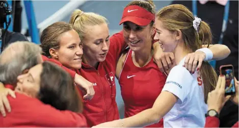  ?? — ap ?? Sheer joy: belina bencic (with cap) celebrates with her Switzerlan­d teammates after beating Czech republic’s Karolina Pliskova to put her team into the final of the billie Jean Cup.