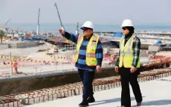  ??  ?? KUWAIT CITY: Ahmad Al-Hassan (left), assistant undersecre­tary for road engineerin­g at the public works ministry and project engineer Mai AlMessad walk at the constructi­on site of the Jaber Causeway in Kuwait City on February 11, 2017. —Photos by Yasser Al-Zayyat