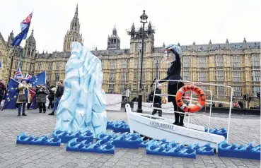  ?? PHOTOS: REUTERS ?? AntiBrexit campaigner­s from global activism group Avaaz take part in a demonstrat­ion with a mock Titanic, outside parliament in Westminste­r in London on January 15.