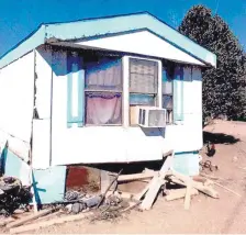  ?? FEDERAL COURT EXHIBIT ?? Federal agents found clothes and hundreds of pairs of shoes strewn about the yard of this mobile home.