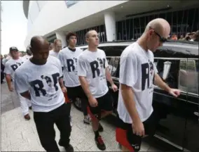  ?? WILFREDO LEE — THE ASSOCIATED PRESS ?? Somber Miami Marlins players, including Mike Donn (40), J.T. Realmuto (11) and Christian Yelich (21), walk alongside a hearse carrying the body of pitcher Jose Fernandez as it leaves Marlins Park stadium, Wednesday in Miami. Fernandez was killed in a...