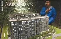  ??  ?? AYALA LAND Premier Managing Director Mike Z. Jugo presents a scale model of the three blocks of Arbor Lanes, the company’s flagship project in integrated mixed-use developmen­t Arca South in Taguig City. The first two towers are almost fully sold out,...