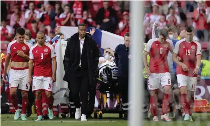  ?? Photograph: Friedemann Vogel/AP ?? Christian Eriksen is taken off the pitch on a stretcher. The Denmark midfielder is in a stable condition and will stay in hospital for further tests.