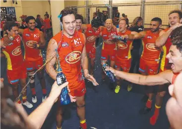  ??  ?? BRING IT ON: Young Gold Coast Suns defender Jack Leslie gets a Gatorade shower after the team’s victory against Carlton. Picture: MICHAEL KLEIN