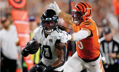  ?? Photograph: Joseph Maiorana/USA Today Sports ?? Jacksonvil­le Jaguars wide receiver Laviska Shenault Jr runs after the catch as Cincinnati Bengals linebacker Logan Wilson pursues during the third quarter at Paul Brown Stadium.