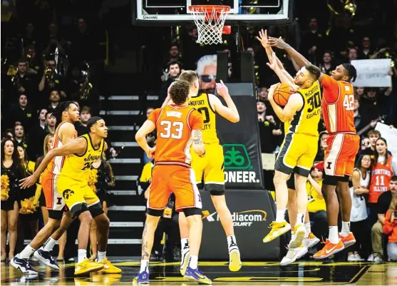  ?? JOSEPH CRESS/AP ?? Connor McCaffery snags the rebound at the buzzer off an intentiona­lly missed free throw by Coleman Hawkins to close out Iowa’s home-court victory over Illinois.