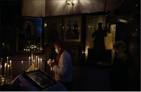  ?? FELIPE DANA — THE ASSOCIATED PRESS ?? A woman attends a Christmas Mass at an Orthodox Church in Bobrytsia, outskirts of Kyiv, Ukraine, on Sunday.