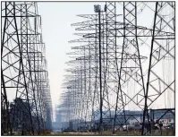  ?? (AP file photo) ?? Towers supporting power lines stretch to the horizon near Houston, Texas. The federal government says it is making more than $8 billion available to improve America’s aging electric grid.