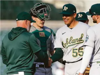  ?? Duane Burleson / Getty Images ?? Adrián Martínez worked 51⁄3 scoreless innings in a 4-1 A’s win that secured a split Tuesday after the Tigers won 6-0 in Game 1. Twenty-one Detroit hitters faced him and totaled four singles.