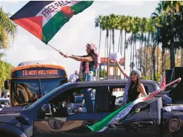  ?? DAMIAN DOVARGANES/AP ?? Pro-Palestinia­n protesters stage a Black Friday rally Nov. 23 calling for a permanent end to the Israel-Hamas war outside the Grove in Los Angeles.