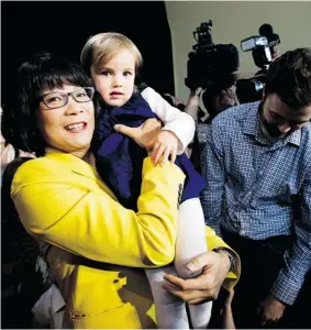  ?? NATHAN DENETTE/The Canadian Press ?? Toronto mayoral candidate Olivia Chow holds her granddaugh­ter Solace Campbell, 2,
after announcing her candidacy on Thursday in Toronto.