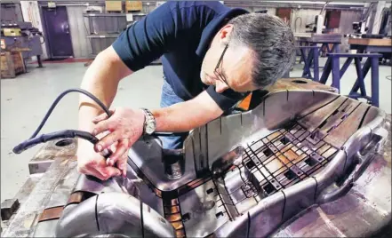  ?? Photos by Charlie Nye, Indianapol­is Star ?? Years of experience: Don Myers, a tool maker for 22 years, works on a plastic injector mold for child safety seats at Overton Industries’ plant.