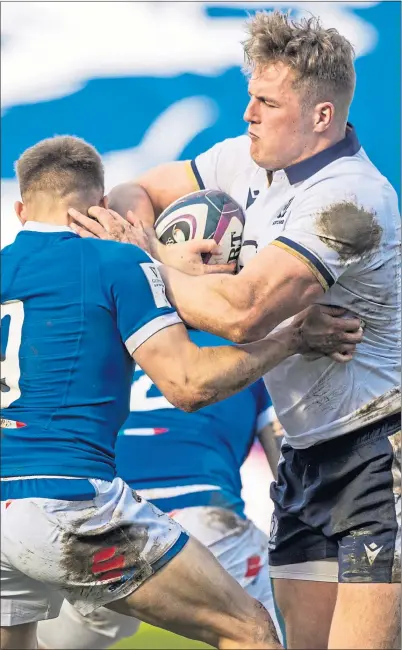  ??  ?? Duhan van der Merwe brishes aside Italy’s Stephen Varney at Murrayfiel­d