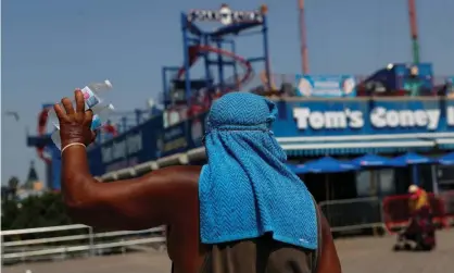  ?? Photograph: Shannon Stapleton/Reuters ?? A man sells water on the boardwalk of Coney Island in New York last month.