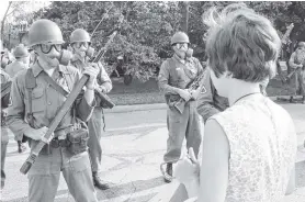  ?? PHOTO: BETTMANN ARCHIVE ?? Faceoff . . . An antiwar demonstrat­or stands opposite National Guard soldiers, in Chicago, in 1968. The city hosted the Democratic National Convention, and running battles between protesters against the Vietnam War and police, in August of that year.