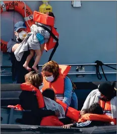  ??  ?? RESCUE: A group including children, above, are brought into Dover yesterday by a Border Force vessel as calm weather has increased crossings
