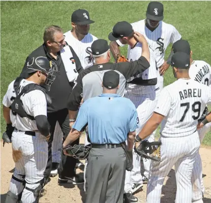  ?? GETTY IMAGES ?? Sox manager Rick Renteria puts an arm around pitcher Dylan Covey, who left the game Saturday in the fifth inning with an injury near his groin.