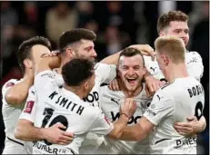  ?? Photo: AFP ?? Boreham Wood’s Mark Ricketts (centre) celebrates with teammates after scoring against Bournemout­h.