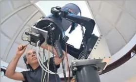  ?? Photo: Andre van Staden ?? Calibratio­ns: A member of ASSA preparing a telescope for a night’s observatio­n.