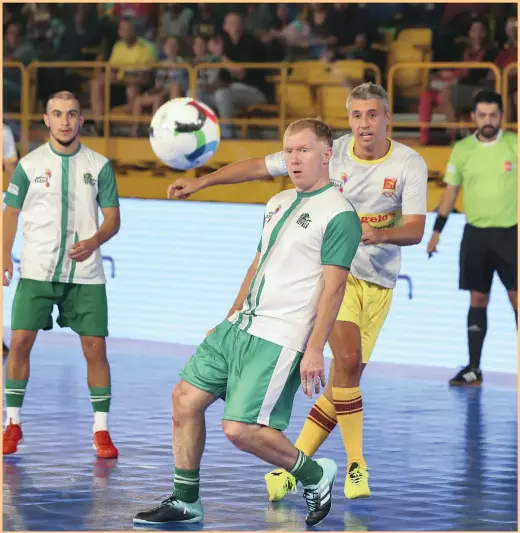  ?? Chris Whiteoak / The National ?? Hernan Crespo, in yellow, hits a shot past Paul Scholes during the second night of action at the Premier Futsal tournament, being held at the Al Wasl Sports Club in Dubai. Today is a rest day with the semi-finals tomorrow and Saturday. The final takes...