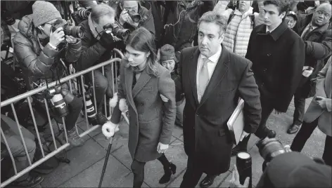  ?? AP PHOTO ?? Michael Cohen, centre, President Donald Trump’s former lawyer, accompanie­d by his children Samantha, left, and Jake, right, arrives at federal court for his sentencing Wednesday in New York.