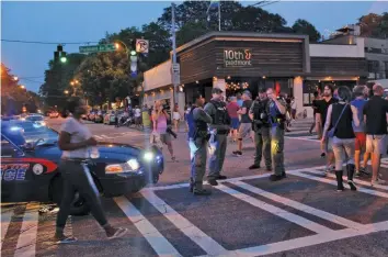  ?? (File photo) ?? Officers from the Atlanta Police Department’s APEX unit were on hand at the local vigils for the victims of the June 12 shooting in Orlando.