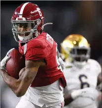  ?? XXX/TNS ?? Wide receiver Devonta Smith (6) of the Alabama Crimson Tide rushes for a touchdown over the defense of the Notre Dame Fighting Irish during the first quarter of the 2021 College Football Playoff Semifinal Game on Jan. 1, 2021 at AT&T Stadium in Arlington, Texas.