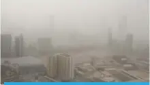  ?? — Photo by Joseph Shagra ?? KUWAIT: The Kuwait City skyline is barely visible during a dust storm yesterday.