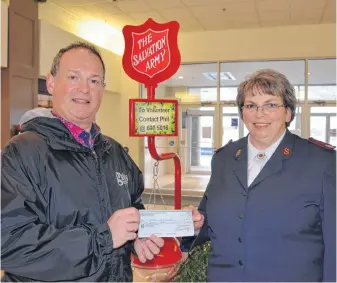  ??  ?? Gates Insurance owner Mike Vardy presents Major Sharon MacLeod of the Kentville Salvation Army with a donation in support of the Christmas Kettle Campaign.