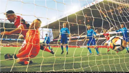  ??  ?? Nottingham Forest defender Eric Lichaj (left) heads the first goal past Arsenal goalkeeper David Ospina (2nd left) during yesterday’s English FA Cup 3rd round match at The City Ground in Nottingham. Forest won 4-2. – REUTERSPIX