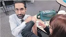  ?? NIAGARA REGION PUBLIC HEALTH ?? Acting regional medical officer of health Dr. M. MustafaHir­ji puts his money where his mouth is and gets his flu shot.