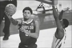  ?? ASSOCIATED PRESS ?? BAYLOR GUARD MACIO TEAGUE drives to the basket ahead of Iowa State guard Jalen Coleman-Lands (right) during the second half of a game, Saturday in Ames, Iowa.