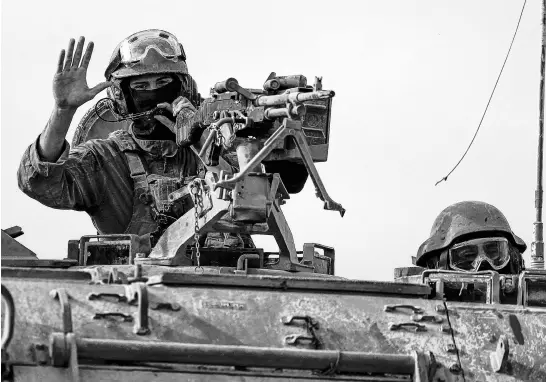  ?? REUTERS ?? Israeli military personnel drive an armoured personnel carrier on April 3 near the Israel-gaza border, amid the ongoing conflict between Israel and the Palestinia­n Islamist group Hamas.