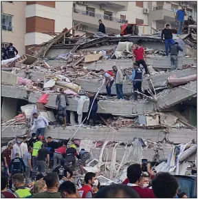  ?? More photos at arkansason­line.com/1031izmir/. (AP/Ismail Gokmen) ?? Rescuers try to save people trapped in the debris of a collapsed building Friday in Izmir, Turkey, after a strong earthquake struck in the Aegean Sea. At least 19 people were killed and more than 700 injured in building collapses and flooding from a small tsunami, officials said. The quake left at least two people dead on the Greek island of Samos.