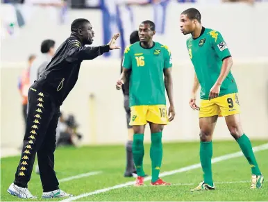  ?? FILE ?? Jamaica head coach Theodore Whitmore (left) gives instructio­ns to Ryan Johnson (right) and Omar Daley during the first half of a CONCACAF Gold Cup match in 2011.