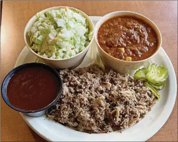  ?? COURTESY OF JOY LLEWALLYN ?? Old South Bar-b-q’s Cole Slaw alongside the restaurant’s Brunswick stew, chopped BBQ pork and a dish of their original barbecue sauce.
