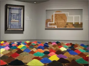  ?? The Associated Press ?? FINAL FRONTIER: Bolivian artist Sonia Falcone’s “Campo de Color (Color Field)” is displayed in the foreground on Aug. 30 at the exhibit ‘’Unsettled,’’ on display into January at the Nevada Museum of Art in Reno, Nev. It consists of 88 terracotta bowls...