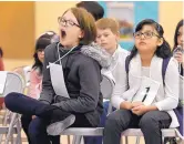  ??  ?? Fifth-grade students Esme LaPointe, left, and Auriana Rey wait their turns to spell during the 2017 Rio Rancho Public Schools spelling bee.