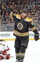  ?? WINSLOW TOWNSON/USA TODAY SPORTS ?? The Bruins’ David Pastrnak celebrates his power play goal with the Hurricanes’ Brett Pesce behind him on Friday in Boston.