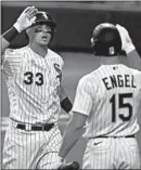  ?? CHRIS SWEDA/CHICAGO TRIBUNE ?? James McCann is congratula­ted by White Sox teammate Adam Engel after hitting a solo home run Saturday.