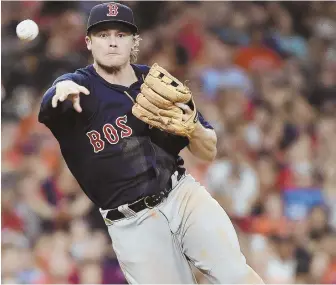  ?? AP PHOTO ?? THROW HIM IN: Josh Rutledge, who got the start at third base in place of Pablo Sandoval, makes a play on the Astros' Derek Fisher during the Red Sox' 2-1 victory.