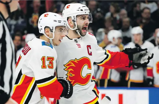  ?? JEFFREY T. BARNES/THE ASSOCIATED PRESS ?? Calgary’s Johnny Gaudreau, left, celebrates a goal with Mark Giordano during the second period against the Buffalo Sabres on Wednesday.