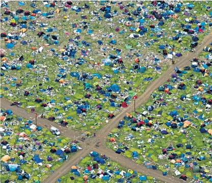  ??  ?? The abandoned camping equipment left at Reading festival, where last year over 13,000 tents were left behind. Dua Lipa, the singer, left, performed at the festival on Saturday